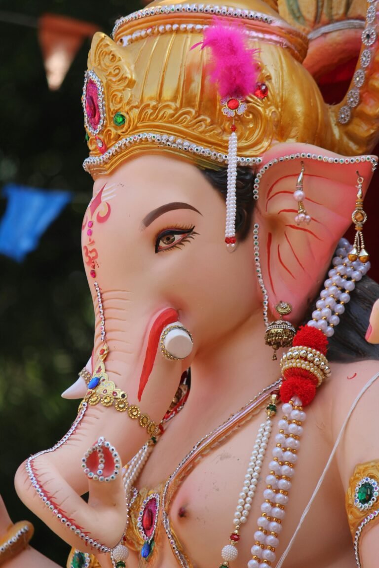 Detailed close-up of a colorful Ganesh statue adorned with jewels.